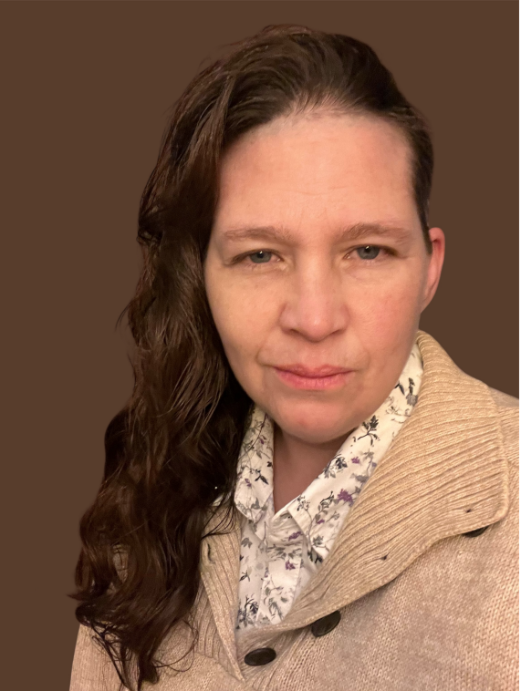 Woman with long dark haired wearing a cream jacket